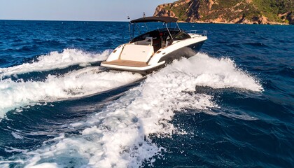A motorboat cuts through the azure ocean, leaving a wake of white foam in its path.