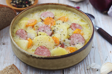 A bowl with traditional German potato soup with sausages