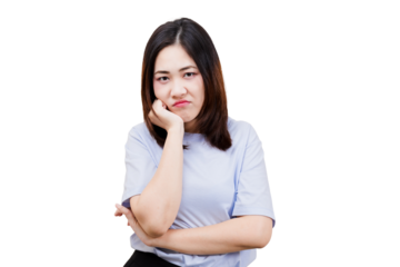 Asian young beautiful woman with a frustrated expression rests her chin on her hand, arms crossed, showcasing a mix of annoyance and contemplation.
