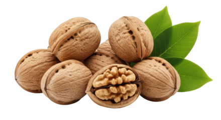 Pile of whole and cracked walnuts with green leaves on background food healthy