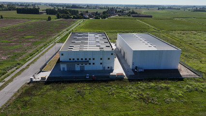 Modern data center facilities situated in a rural Italian landscape in the Lombardy region signifying cloud infrastructure and digital data management services for enterprise solutions