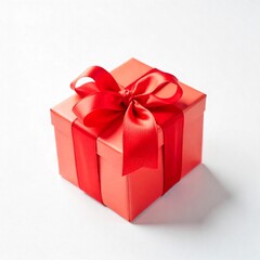 Elegant gift box with red ribbon on plain background.