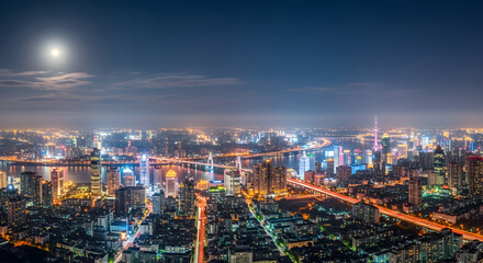 Stunning nighttime panorama of a sprawling metropolis featuring illuminated skyscrapers