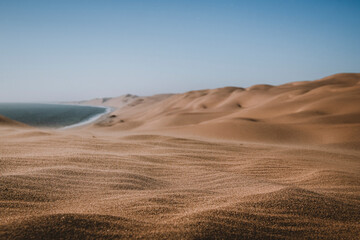 Close up view on sand wavelets blown by the wind