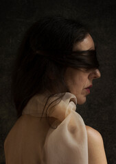 woman with her hair covering her eyes in a romantic attitude VI