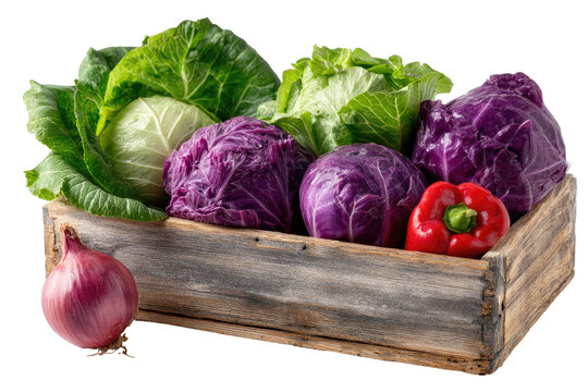 Wooden crate filled with assorted cabbages and a red bell pepper, along with a purple onion