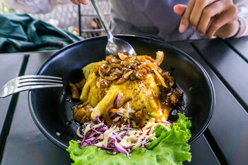 A woman enjoying a delectable chiffon egg chicken teriyaki meal with rice and a fresh side salad. Perfect for food, culinary, and lifestyle concepts