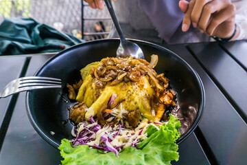 A woman enjoying a delectable chiffon egg chicken teriyaki meal with rice and a fresh side salad. Perfect for food, culinary, and lifestyle concepts