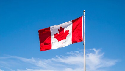 A vibrant Canadian flag billows proudly against a clear blue sky, displaying the iconic red maple leaf.