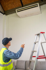 Air Conditioner Maintenance: A technician, dressed in a safety vest, meticulously inspects a modern...