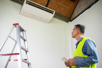 Air Conditioner Inspection: An expert in his field, equipped with a notepad, meticulously examines...