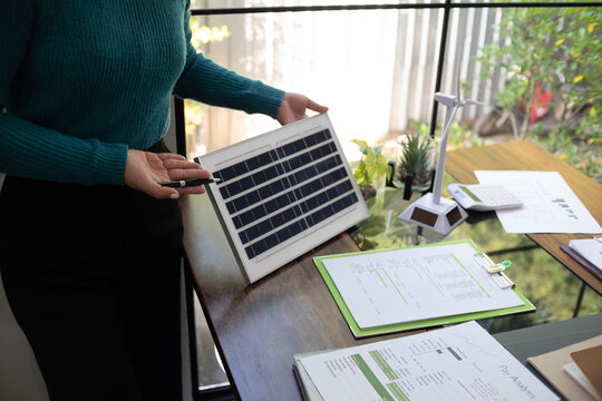 A sales representative presenting solar and wind power, alternative energy, clean energy for future.