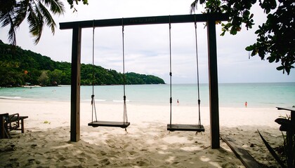 Tranquil wooden swings on a pristine beach, overlooking a serene turquoise ocean.