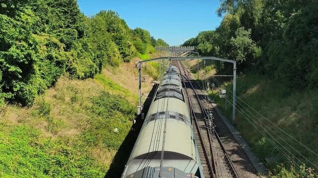 RER A train traveling through green suburbs near Paris, Ile-de-France.