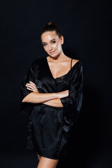 Portrait of a beautiful woman in a black silk robe