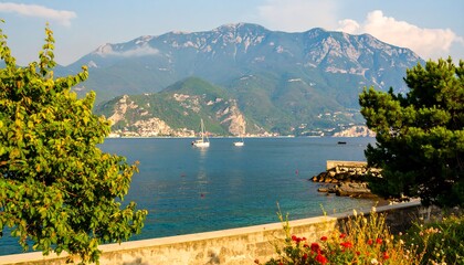 Picturesque coastal scenery showcases a tranquil bay, lush greenery, and majestic mountains.