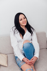 Portrait of a beautiful brunette woman in a white shirt