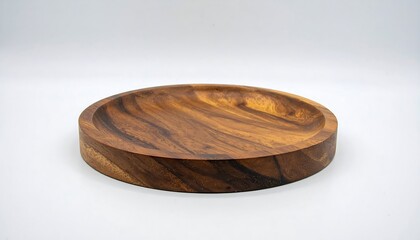 A circular, wooden serving platter showcases rich tones and a smooth, hand-crafted surface.