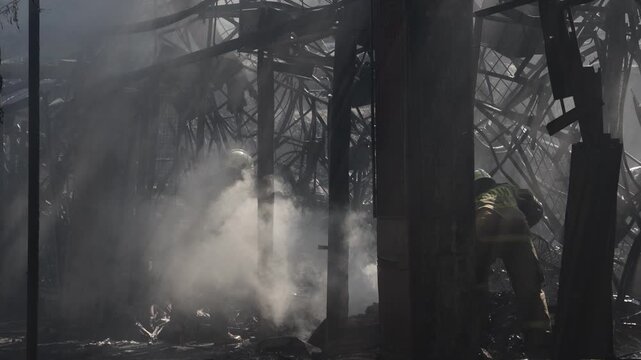 Firefighters extinguish a fire at a market.