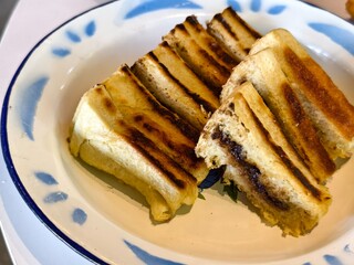 Grilled toasted bread filled with melted Chocolate  on a Vintage Plate