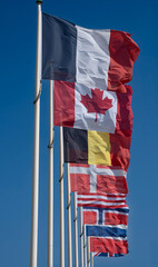 Saint-Aubin-Sur-Mer, France - 08 10 2025: Alignment of national flags of the Allies of the Second...