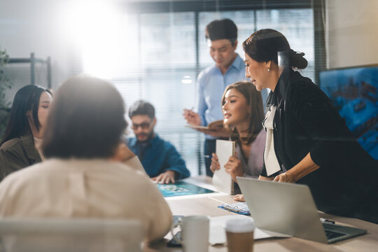 Leader business mature woman asian working together traning team skill positive emotion at modern office