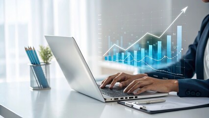 Businesswoman typing on laptop with financial growth chart overlay