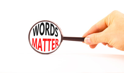 Words matter symbol. Concept word Words matter on beautiful magnifying glass. Businessman's hand....