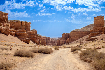 Fototapeta premium A deserted road along an ancient canyon. Landscape background, Kazakhstan