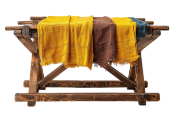 Rustic wooden table with colorful woven throws for a cozy home decor concept on transparent background