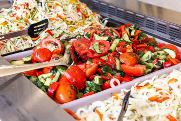 Colorful vegetable salads in buffet trays — fresh, seasonal, and perfect for healthy lifestyle...