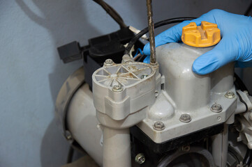 A technician is repairing an old, broken automatic water pump.