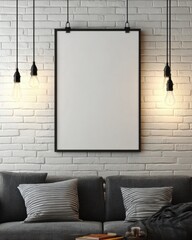 Empty framed art piece on brick wall above gray couch