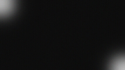 A dark background with two bright white spots