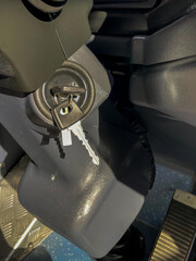 Close-up of vehicle ignition with key inserted in modern bus interior
