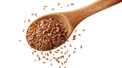 Flaxseeds poured from wooden spoon on transparent background