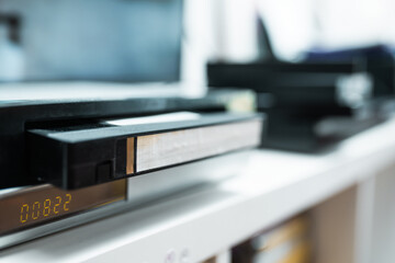 Close up of a hand holding a videotape.