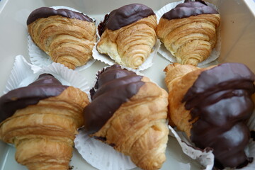 Delicious chocolate croissant pastries offer delightful treat. Golden brown and flaky, each rich...