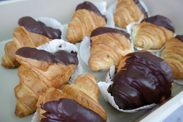 Golden brown chocolate croissant pastry baked with delicious sweet dessert snack, offering delightful treat for morning