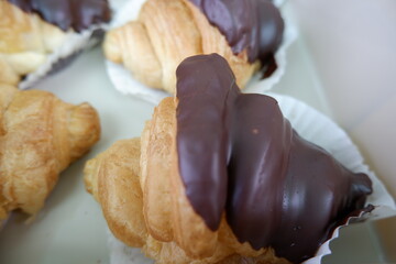 Delicious chocolate croissant delights await, tempting sweet treat freshly baked for breakfast or...