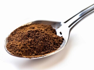 Ground coffee powder in a metal spoon ready for brewing a fresh cup of coffee