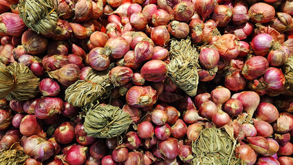 Many fresh bunches of shallots for sale at market or supermarket. Freshness vegetables, harvest of...