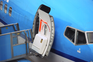Open aircraft passenger door as seen from the gate