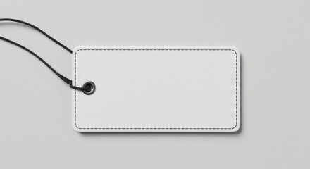 A blank white leather tag with a black string.
