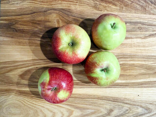 Four Fresh Apples on Wooden Surface