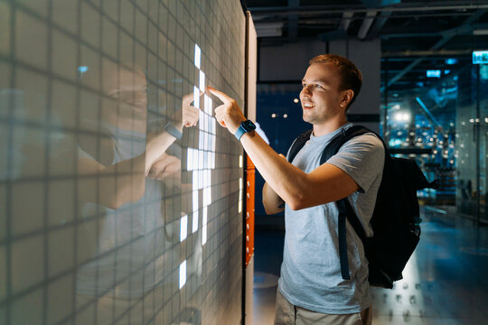 Man Using Interactive Touchscreen Display Indoors