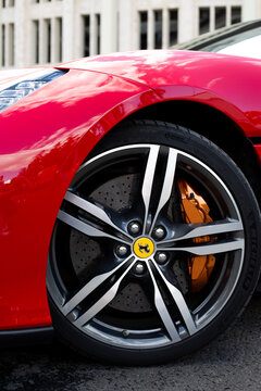Moscow, Russia, August 6, 2025: Vertical shoot of Ferrari Portofino wheel, highlighting large size, sport design and prominent disc brakes with orange calipers. Performance tires and sleek rim design