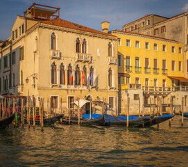 Venetian palaces with gondolas at sunset