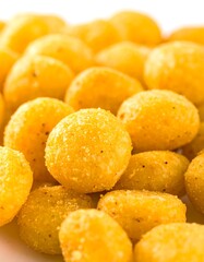 Close-up of many small, round, golden snacks