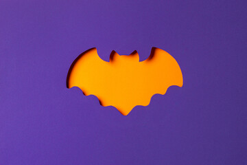 Halloween bat cutout with orange background.